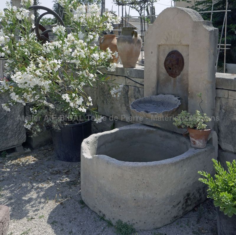 Stone and iron wall fountain | Small garden fountain perfect for decorating a small space with elegance and refinement.