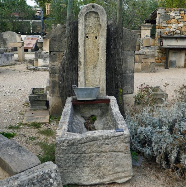 Small fountain: a garden fountain pump and sold with an old stone monolith basin.