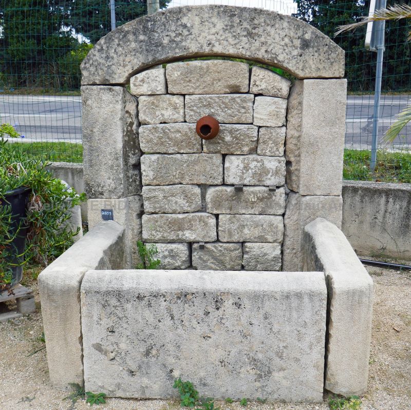 Wall fountain, a garden fountain made of bonded stones.