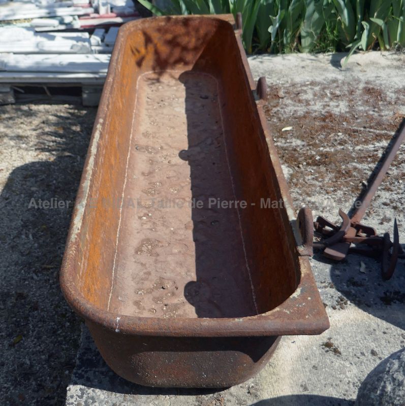 Old trough in cast-iron as outdoors decoration by The Antique Materials in Provence Alain BIDAL