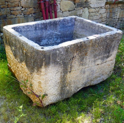 Large massive stone trough as outdoors decoration by Alain Bidal, antique materials in Provence.