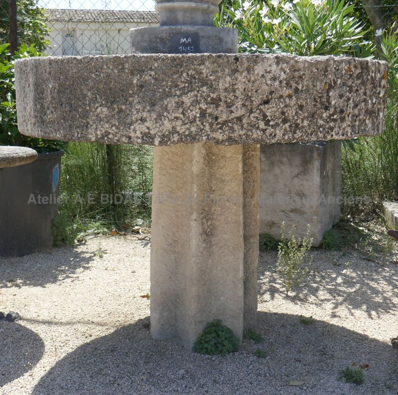 Beautiful round table in old stone with rustic charm for your garden