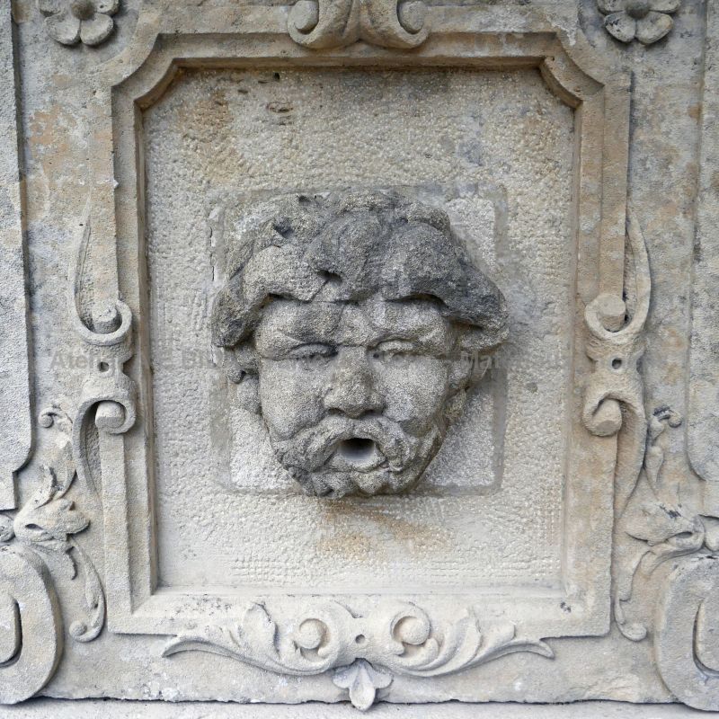 Detail of the hand-sculpted head on our ancient stone fountain
