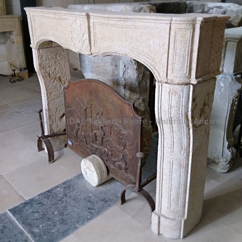 Stone fireplace finely decorated by a craftsman of the 17th century in France, during Louis 15 reign.