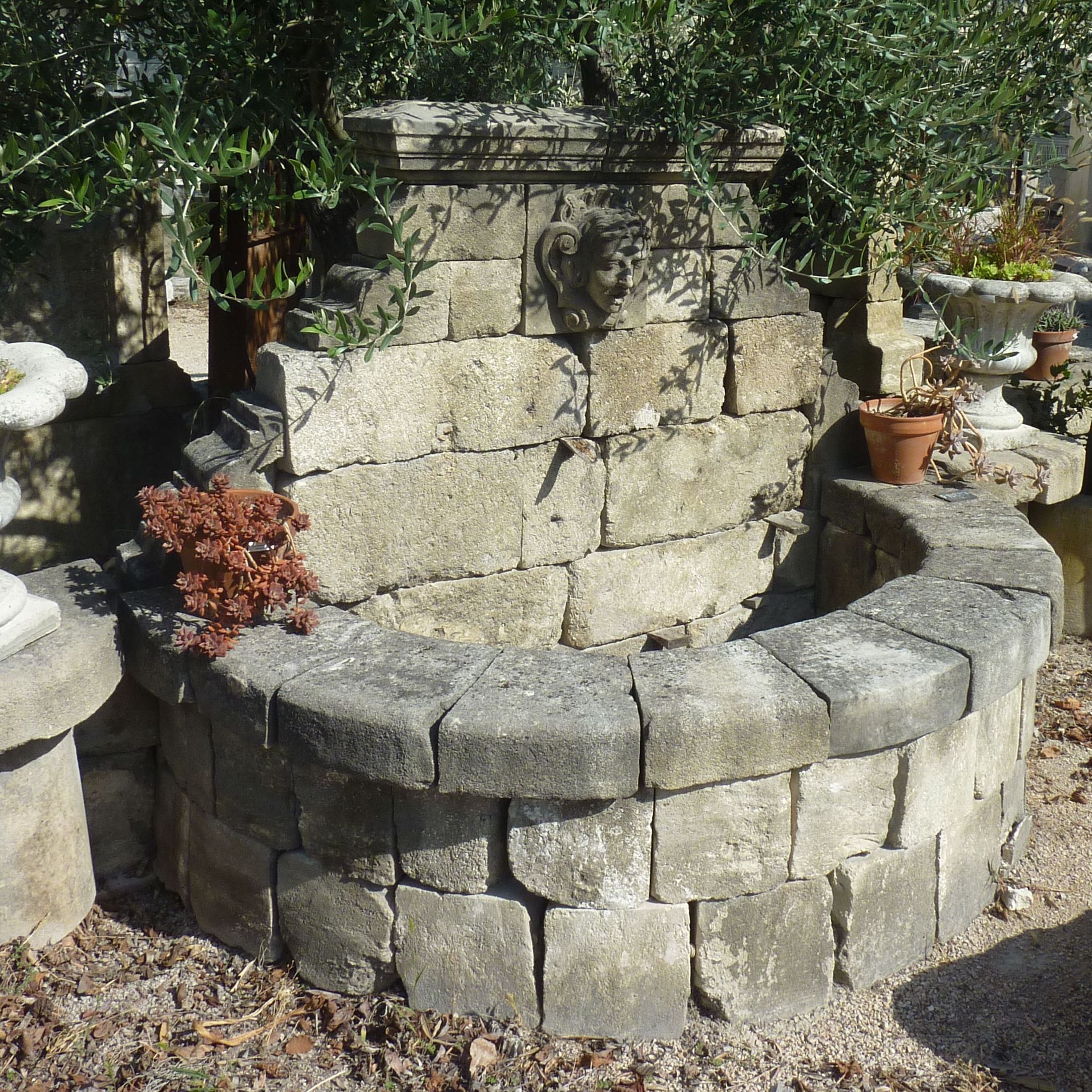 Wallfountain with semicircular basin