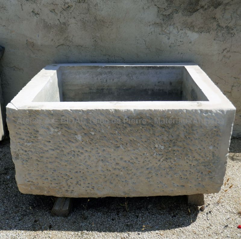Old patinated stone trough : massive trough in stone on sale in Provence at Atelier Alain Bidal.