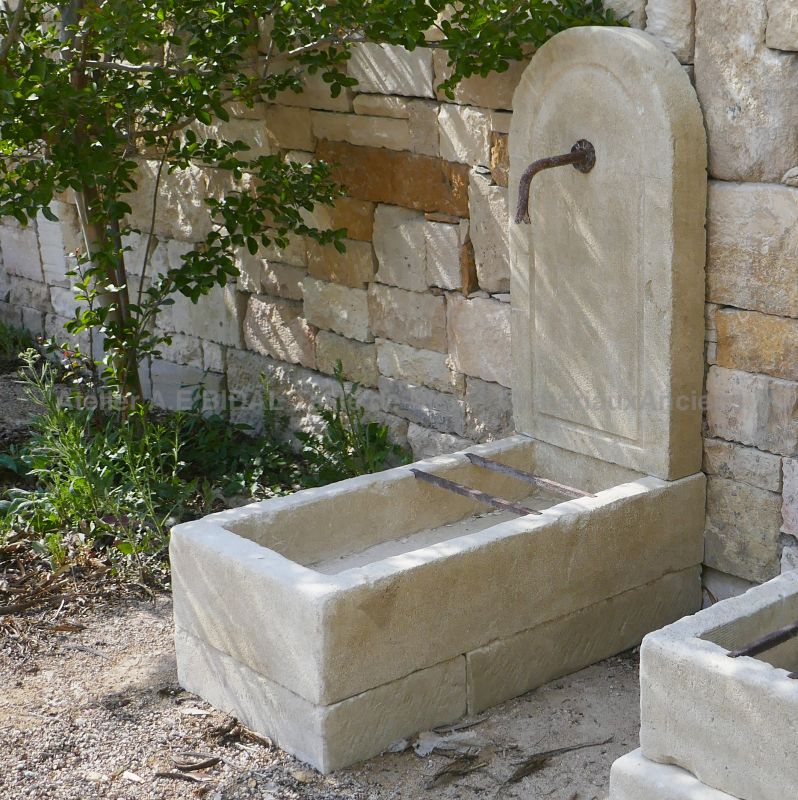 Water fountain in Provencal stone : a small rustic fountain in natural stone