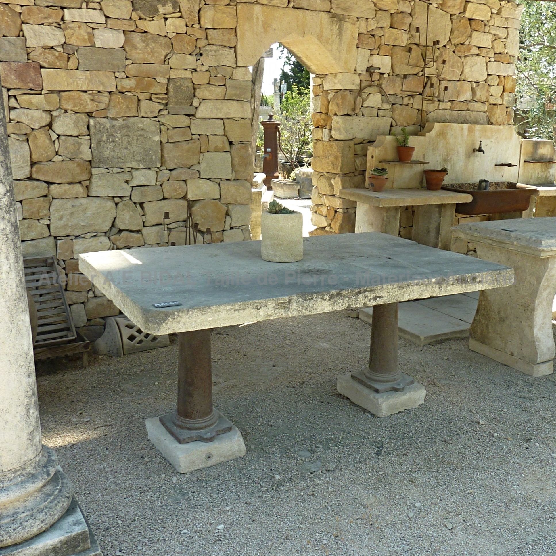 Ancient materials and ancient garden furniture: stone table and rectangular old cast iron for eight people.