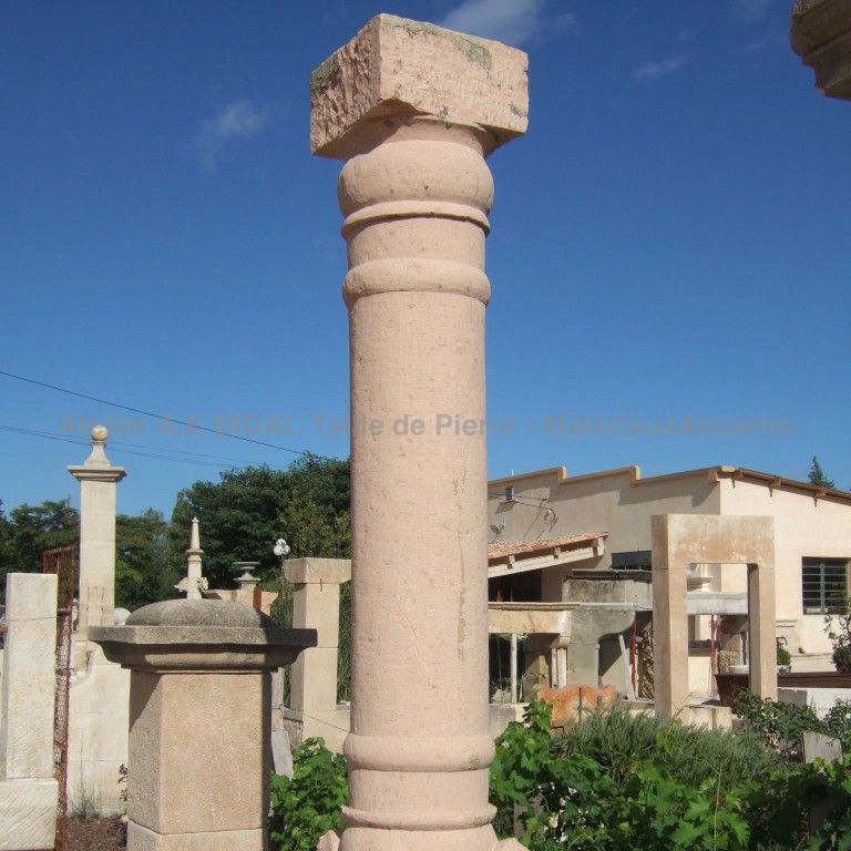 Old pillar made of hard monolith pink stone - old column.