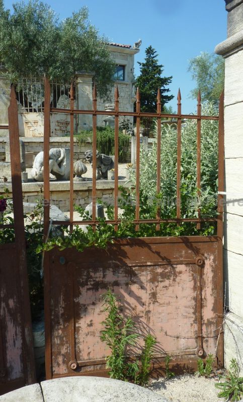 Old gate whose wrought iron has rusted on its surface which gives it a lot of personality.