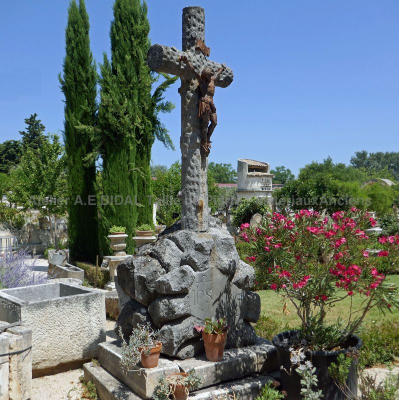 Magnificent stone cross for park or religious space - old cross with Christ made of wrought iron.