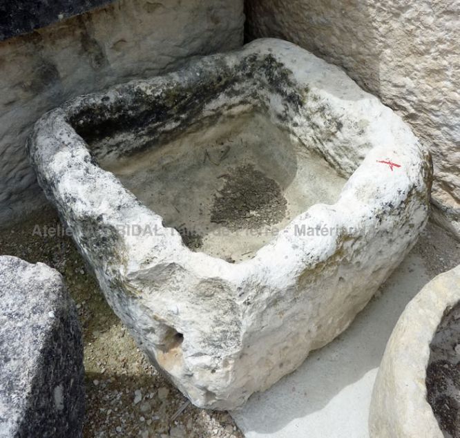 Stone basin - a small old square-shaped stone basin.