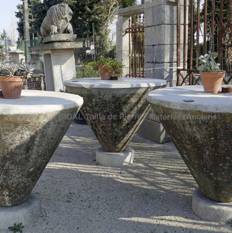 Massive high round table in patined granite stone