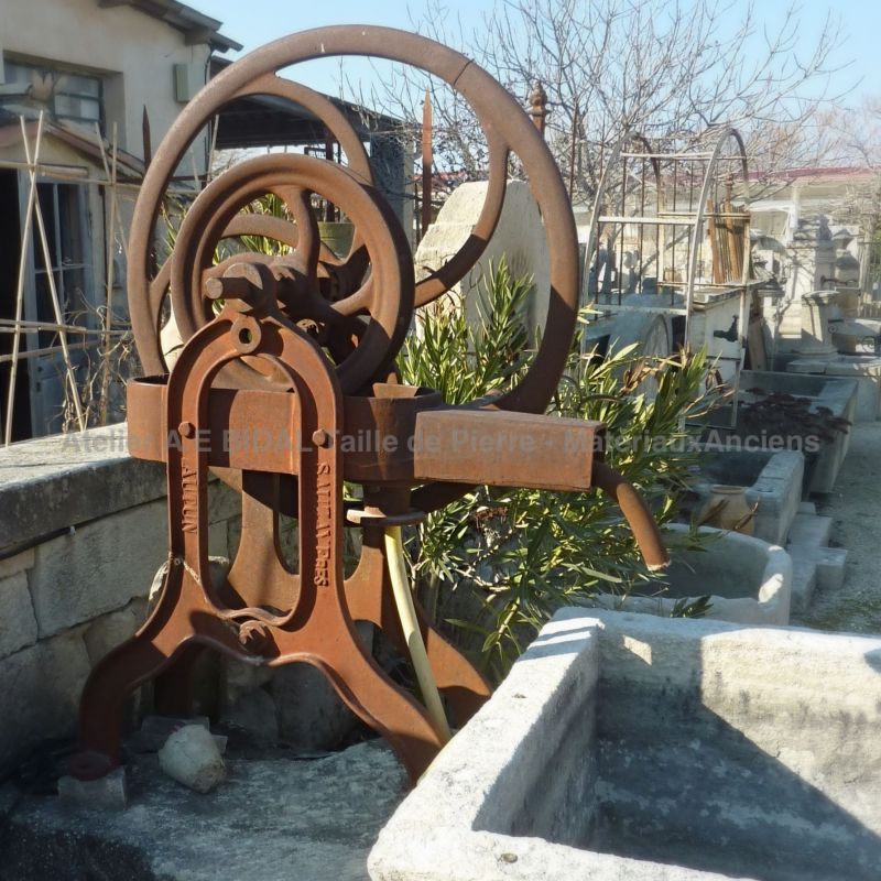 Détail de l'ancienne pompe manuelle en fonte sur notre fontaine ornementale alliant pierres anciennes et fonte.