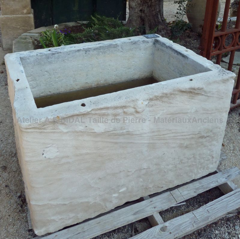 Stone basin with a rustic look that could make a very pretty flower pot or stone planter.