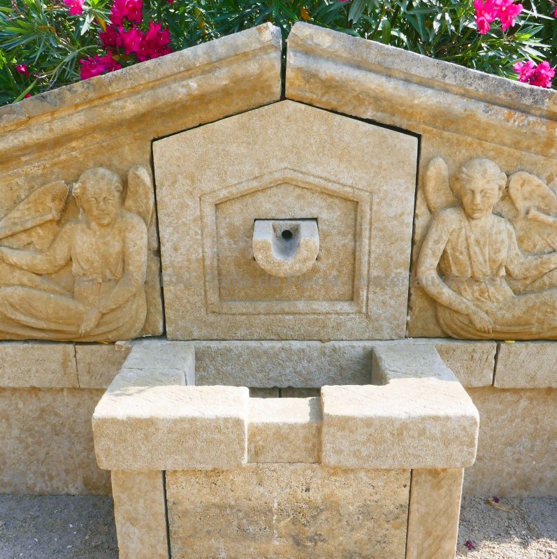 Spillway in stone on our large wall fountain with pediment decorated with a pair of angels with trumpet