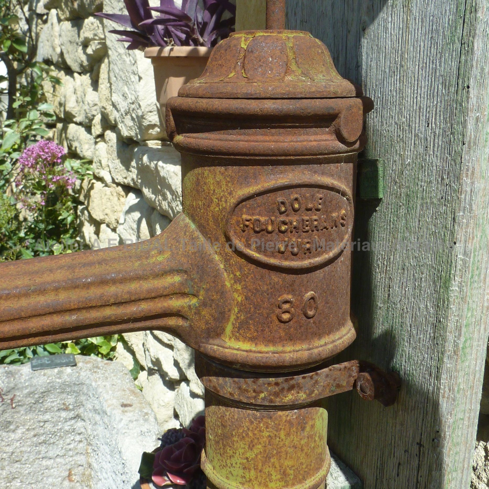 Beautiful water pump with inscriptions - manual pump.