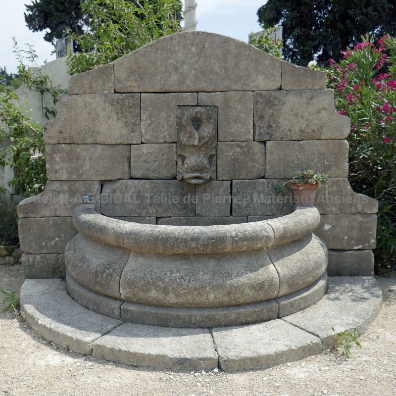 Wall fountain in beautiful aged and patinated stones | Provencal fountain for garden on sale at the stonemason Alain BIDAL.