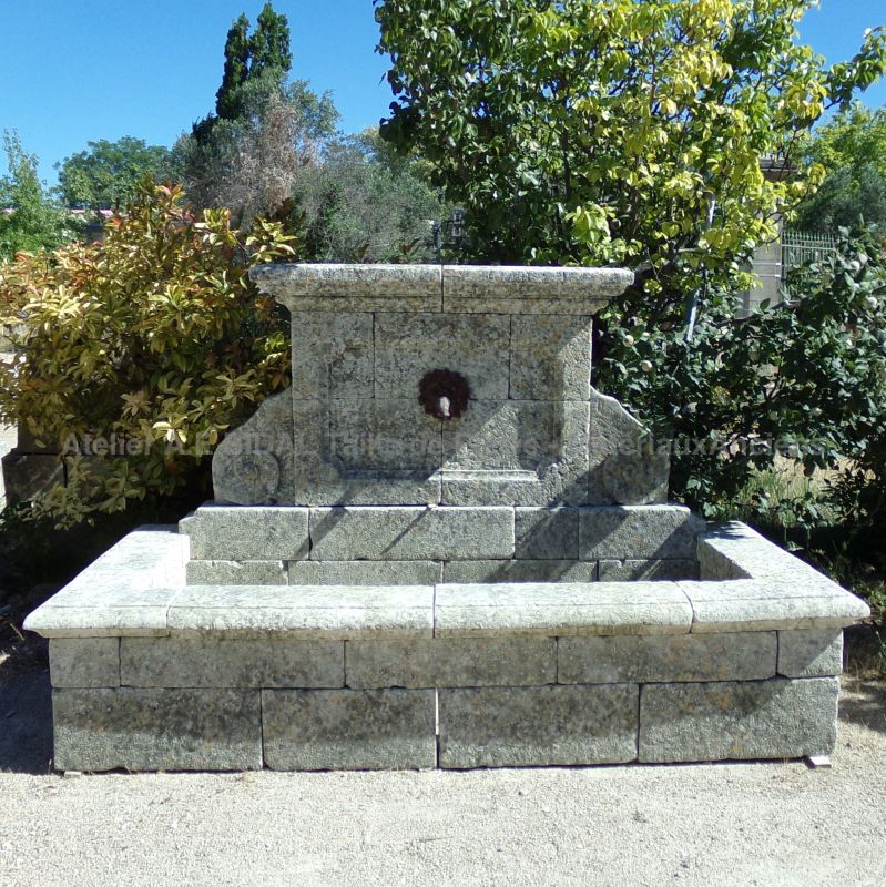 Large rustic-looking fountain in weathered stones by the stonemason in Provence Alain BIDAL