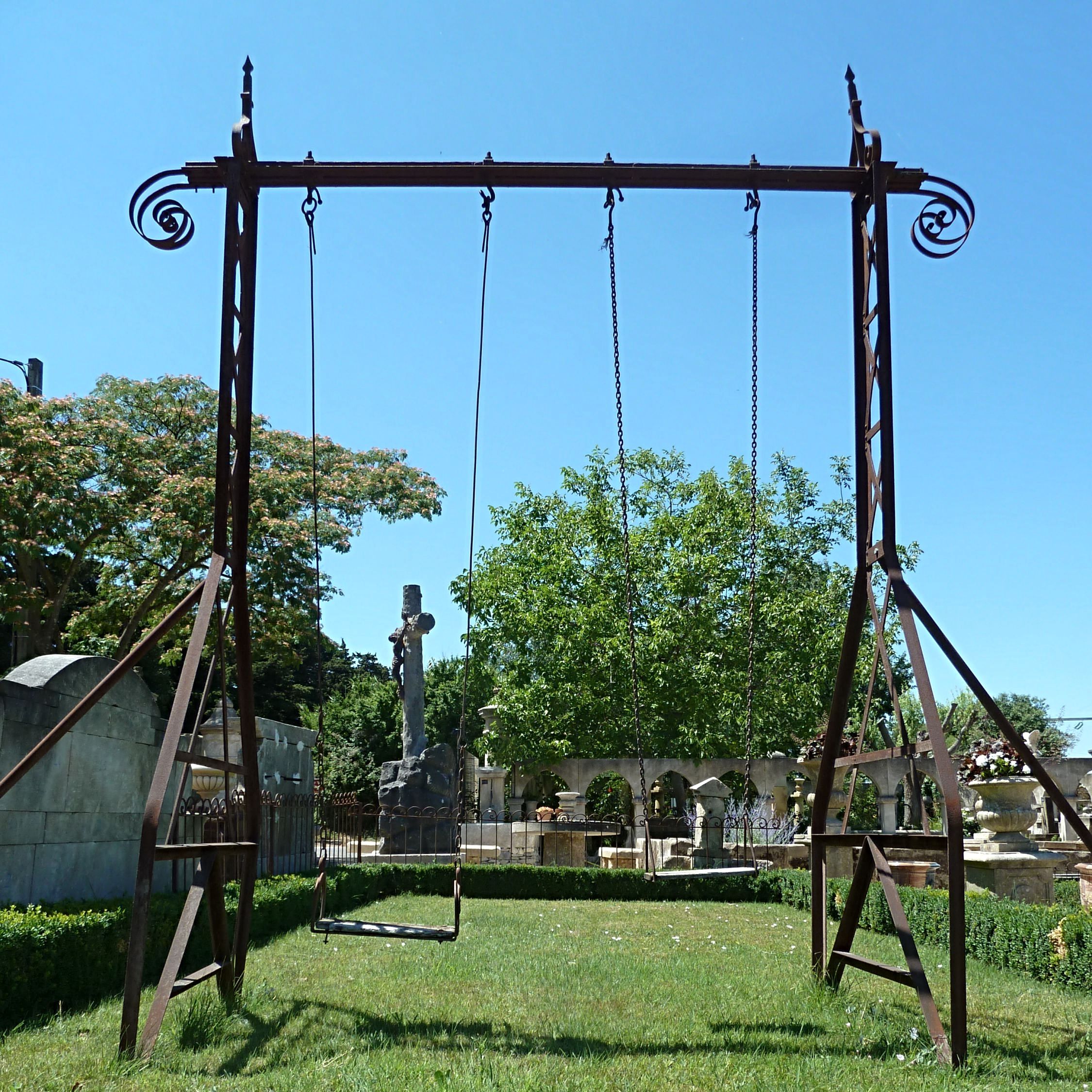 Wrought iron swing - garden games made of old materials.