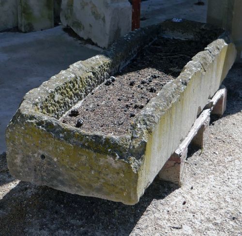 Long antique stone trough for sale at Alain Bidal Antique Materials in Provence.
