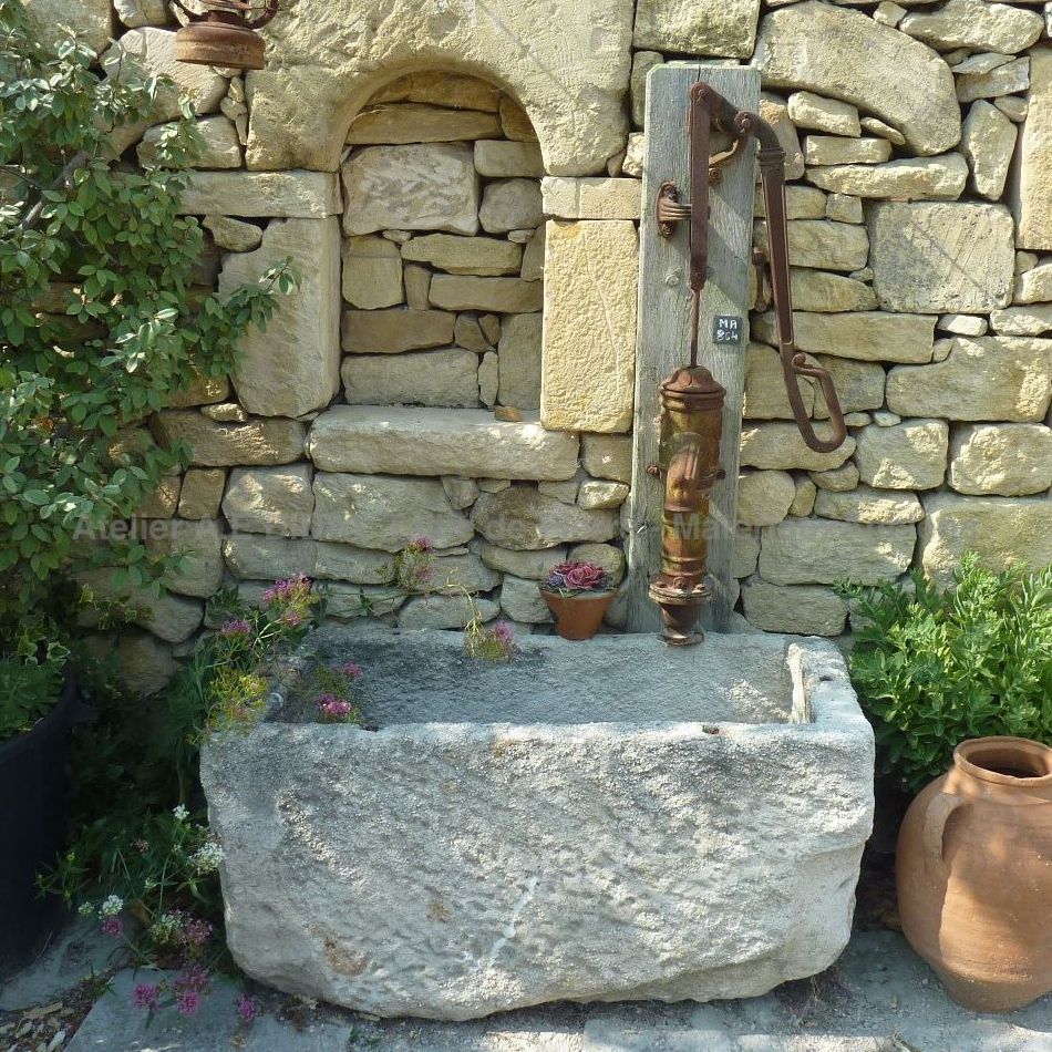 Stone basin or small fountain made of white stone.