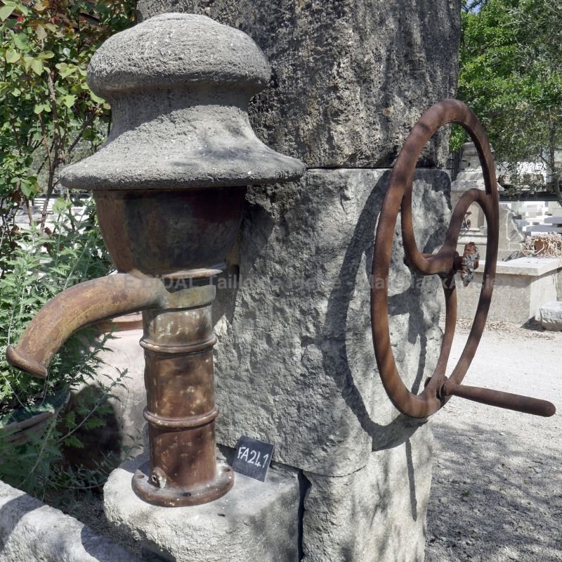 Detail of the antique cast iron manual pump on our garden wall fountain - Atelier Alain BIDAL.