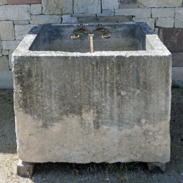 Large old solid trough in hard stone by the craftsman Alain BIDAL