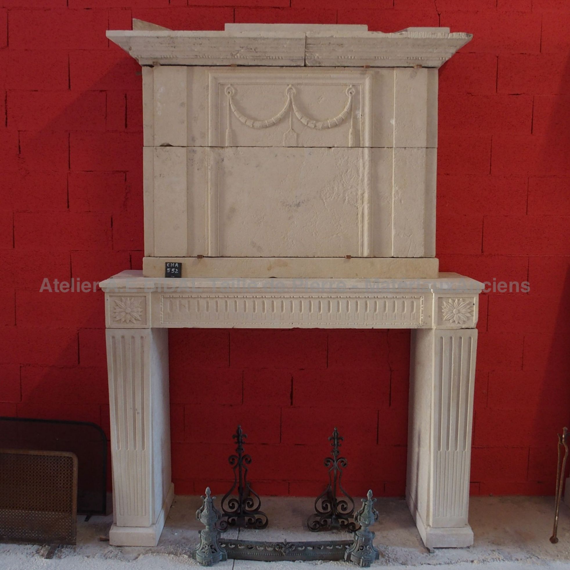 Old fireplace with an overmantle in an yellow-ochre color.
