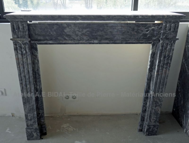 Antique grey marble mantle for sale at Atelier Alain Bidal Antique Materials in Provence.