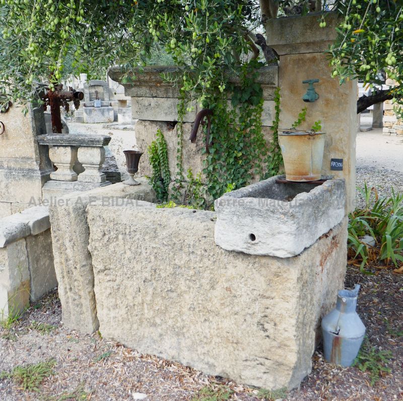 Wall fountain with a rustic look | Garden fountain with two massive troughs and a stone pediment.
