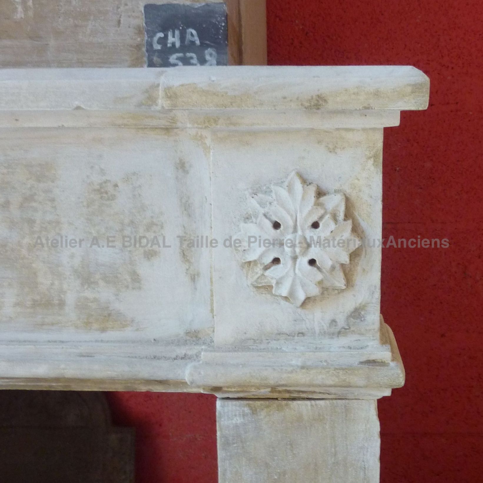 Old fireplace decorated with moldings. It was decorated with care by an old stonemason.