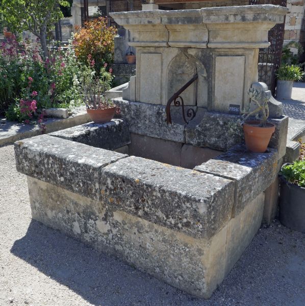 Pretty rustic wall fountain. Old fashionned stone fountain.