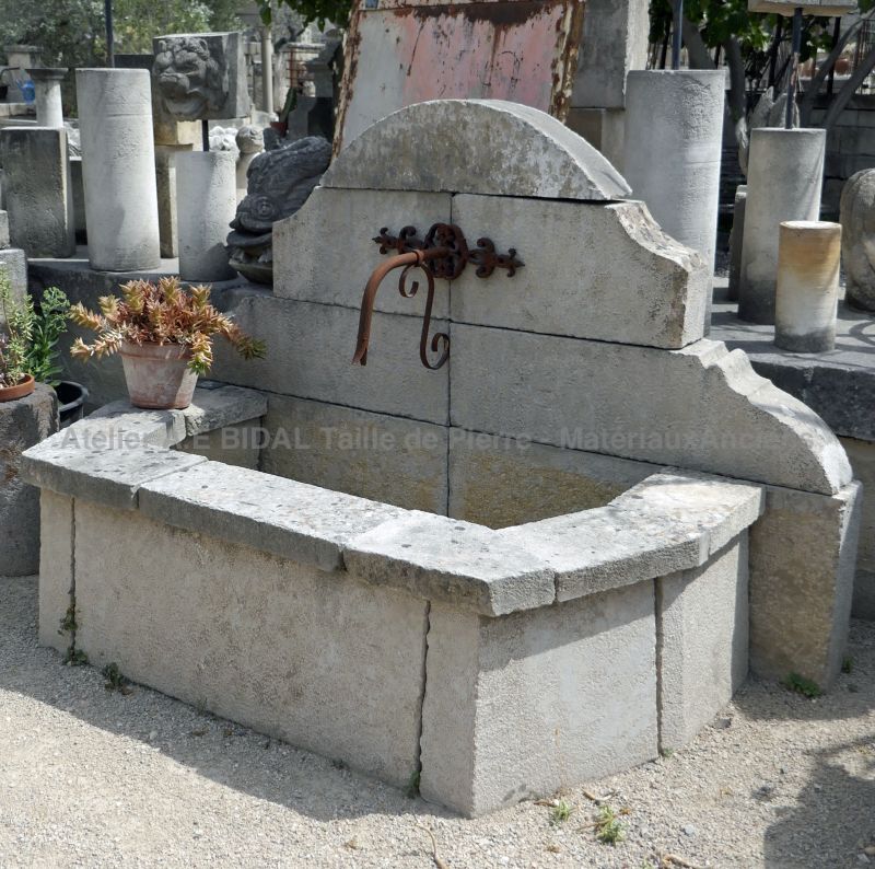 Small decorative fountain - wall fountain with a basin for an outdoor use.