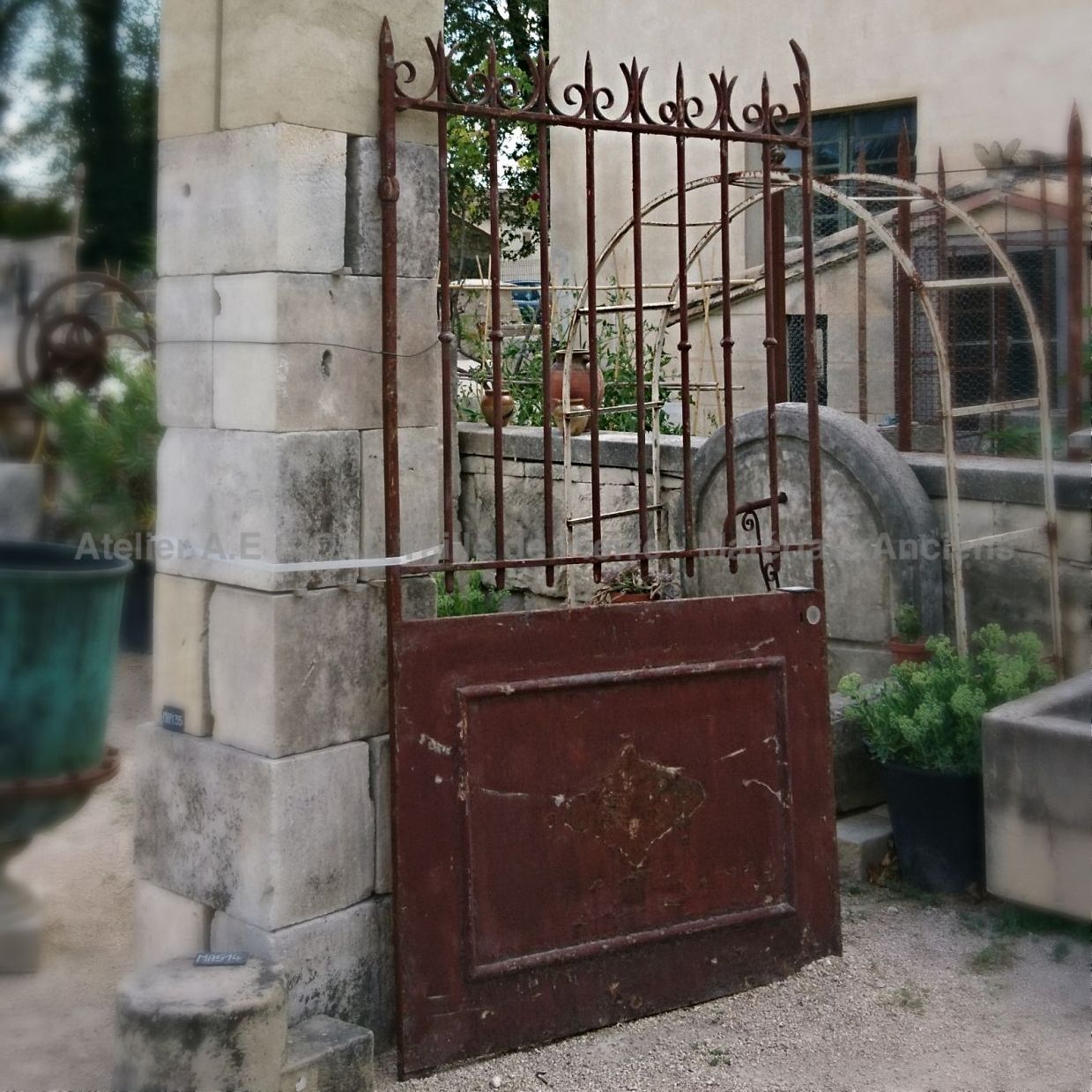 Portail ancien en fer forgé décoré d'une rosace - beau portail de maison.