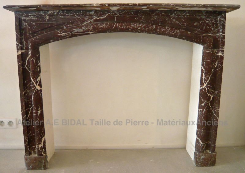 Antique red marble mantle for sale at Alain Bidal Antique Materials in provence.