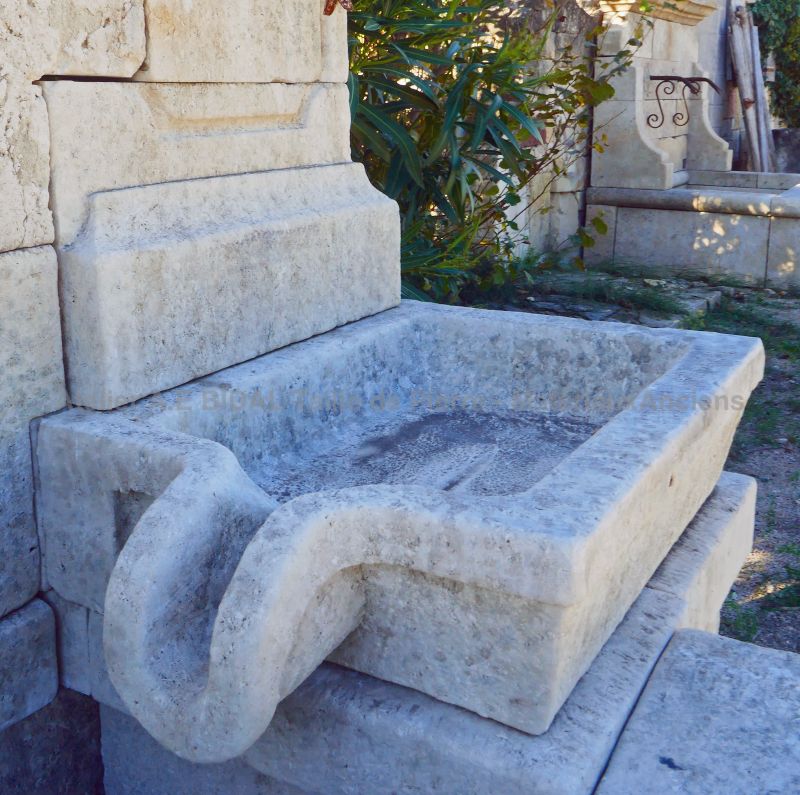 Massive stone sink with sculpted overflow on our large wall fountain in weathered stones