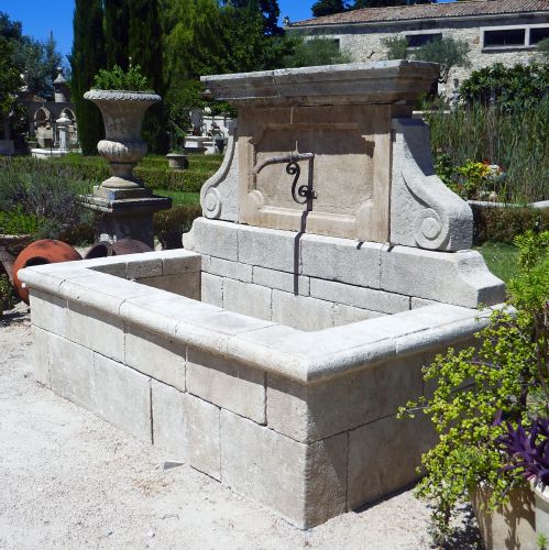 Large rustic-looking fountain in patinated stones by the stonemason in Provence Alain BIDAL