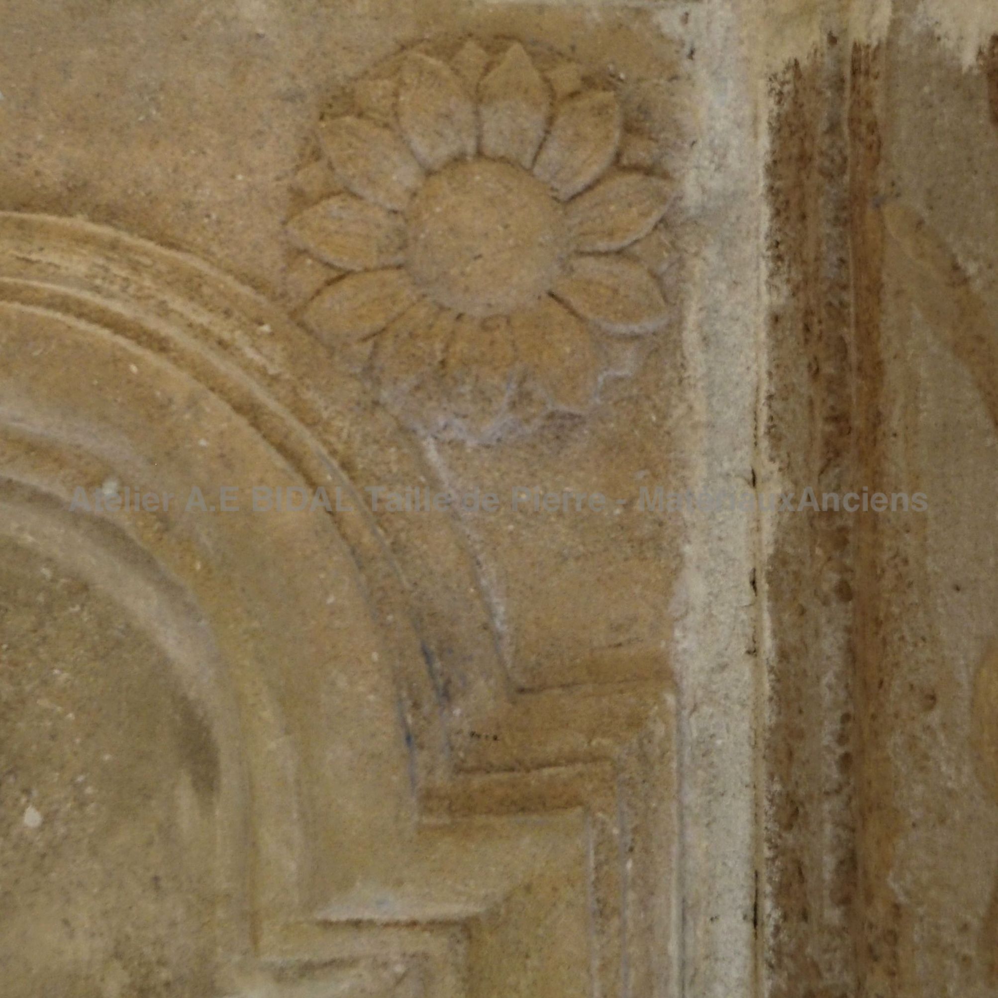 Fireplace with overmantle: stone fireplace with moldings and other decorative elements.