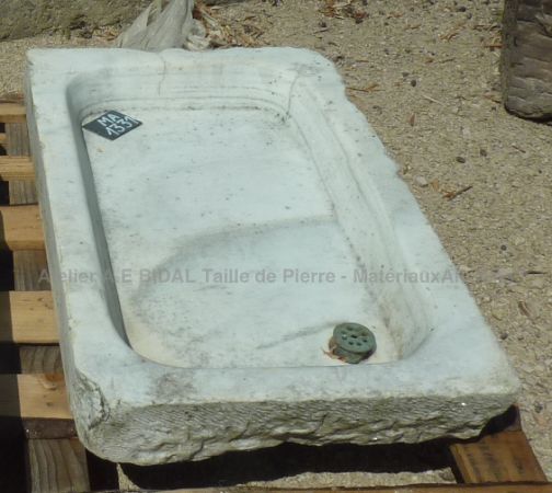 An old sink for indoor or outdoor use - marble stone kitchen sink usable in a summer kitchen.