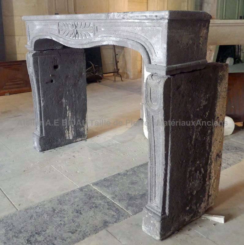 Large antique fireplace mantel in Volvic stone - a 19th century mantelpiece for sale at Atelier Alain BIDAL, Provence