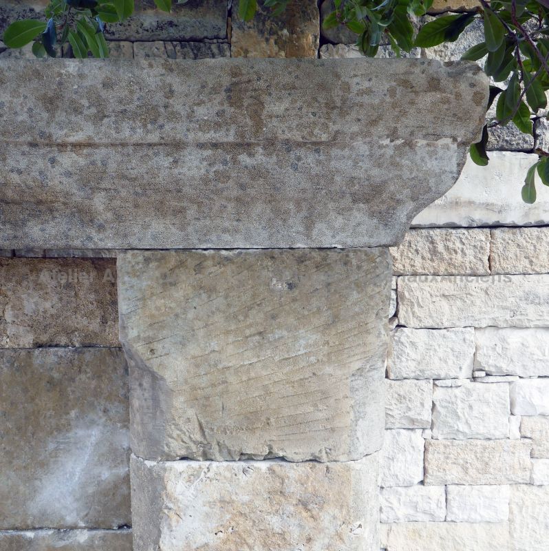 Molded cornice in old weathered stone on the pediment of our garden fountain
