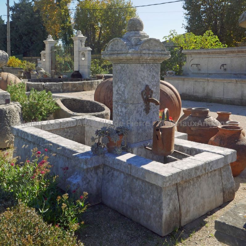 Outdoor fountain with rustic charm : old fountain in natural stone to decorate the garden.