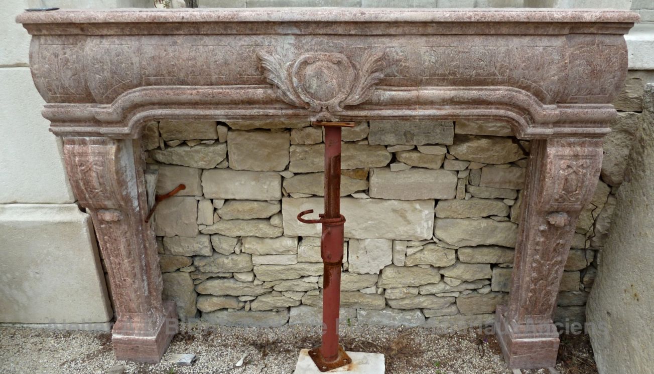 Renaissance fireplace: an elegant pink marble fireplace for interior decoration.