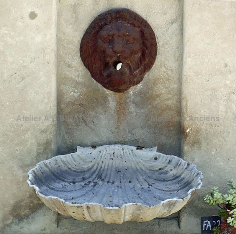 Detail of the water outlet and old cast iron basin on the stone pediment of our decorative garden fountain | Alain BIDAL workshop.