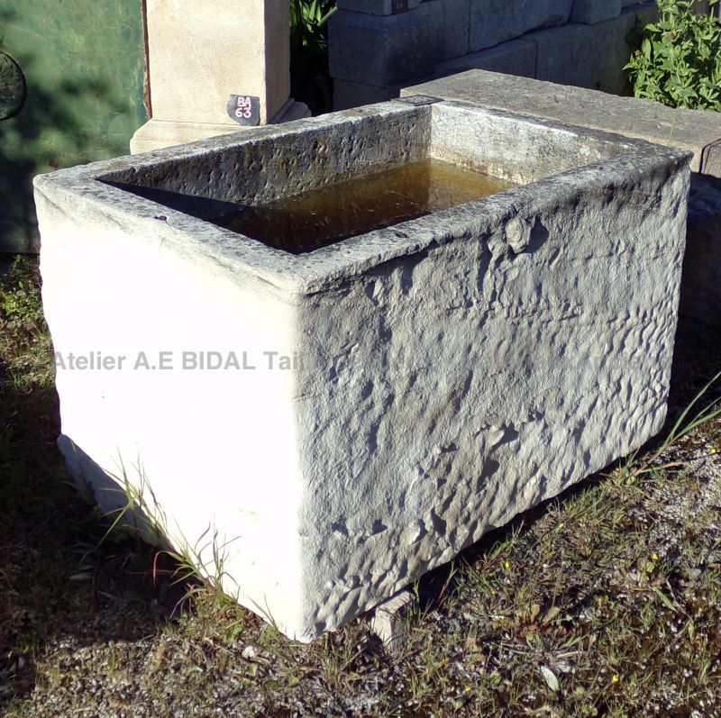 Stone basin with a rustic look that could make a very pretty flower pot or stone planter.