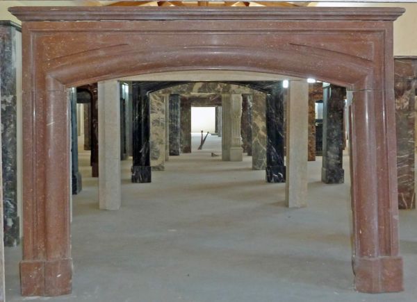 Red marble fireplace - a 19th century fireplace decorated with moldings.