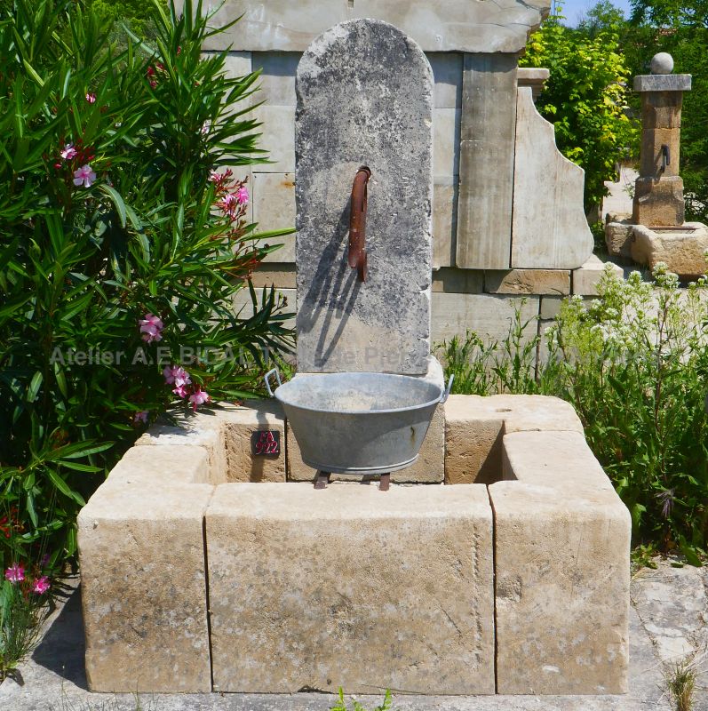 Garden fountain in reclaimed materials : small-sie wall fountain made with old stones by Alain BIDAL (Provence)