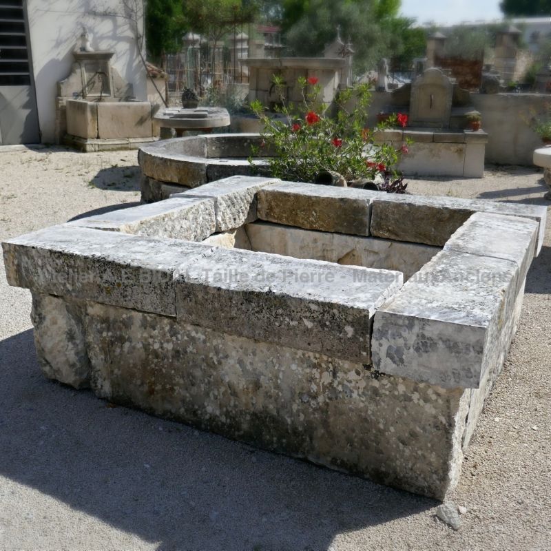 Old stone garden pond on sale at Alain Bidal Antique Materials in Isle sur la Sorgue in Provence.
